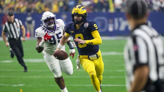 Michigan quarterback J.J. McCarthy runs the ball in the first quarter of the Fiesta Bowl vs. TCU on Saturday, Dec. 31, 2022 at State Farm Stadium in Glendale, Ariz.